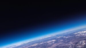 Stunning high-altitude view capturing the Earth's curvature and the fading gradient into space giving a breathtaking glimpse from the edge of the atmosphere.